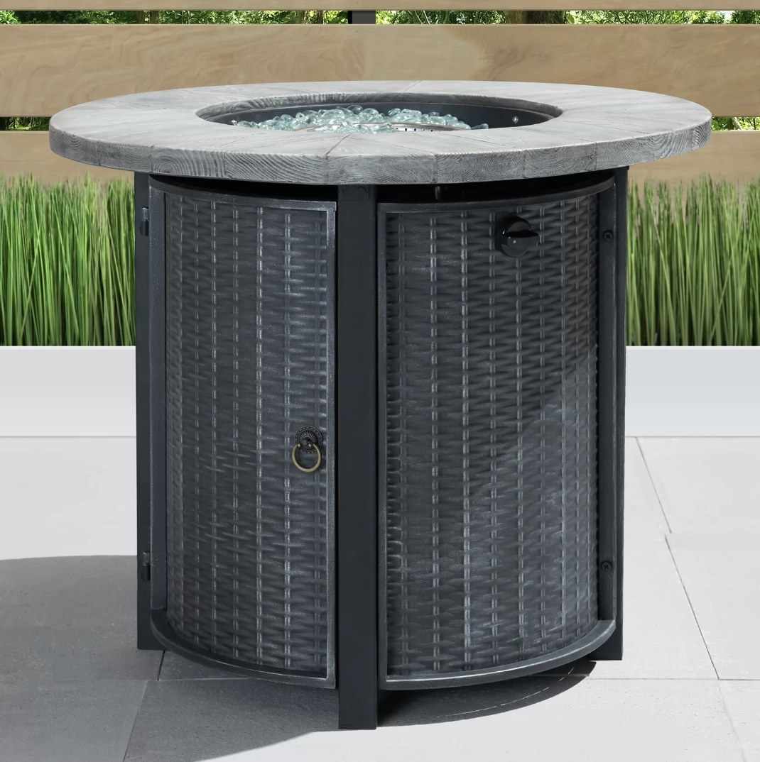 The gray firepit has lattice designed sides