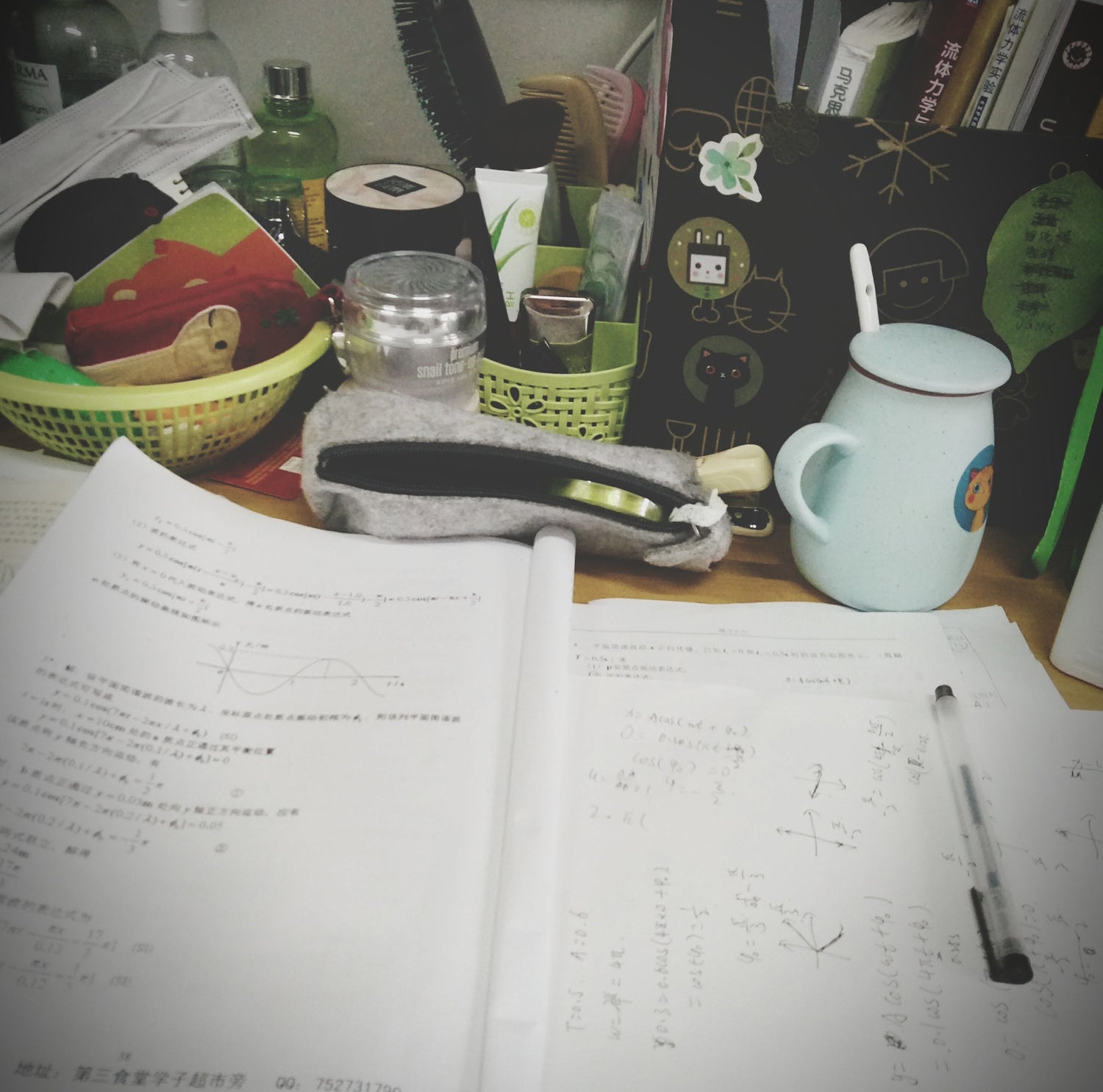 A crowded table with math homework