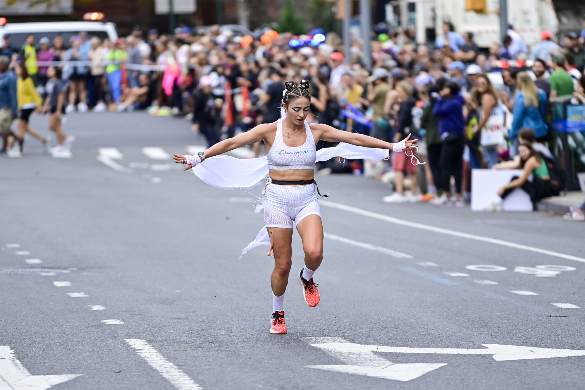 A lone runner holds up their arms to the side