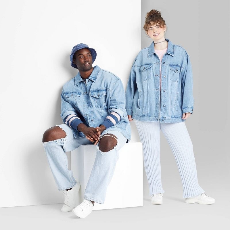 models wearing light blue oversized denim trucker jackets