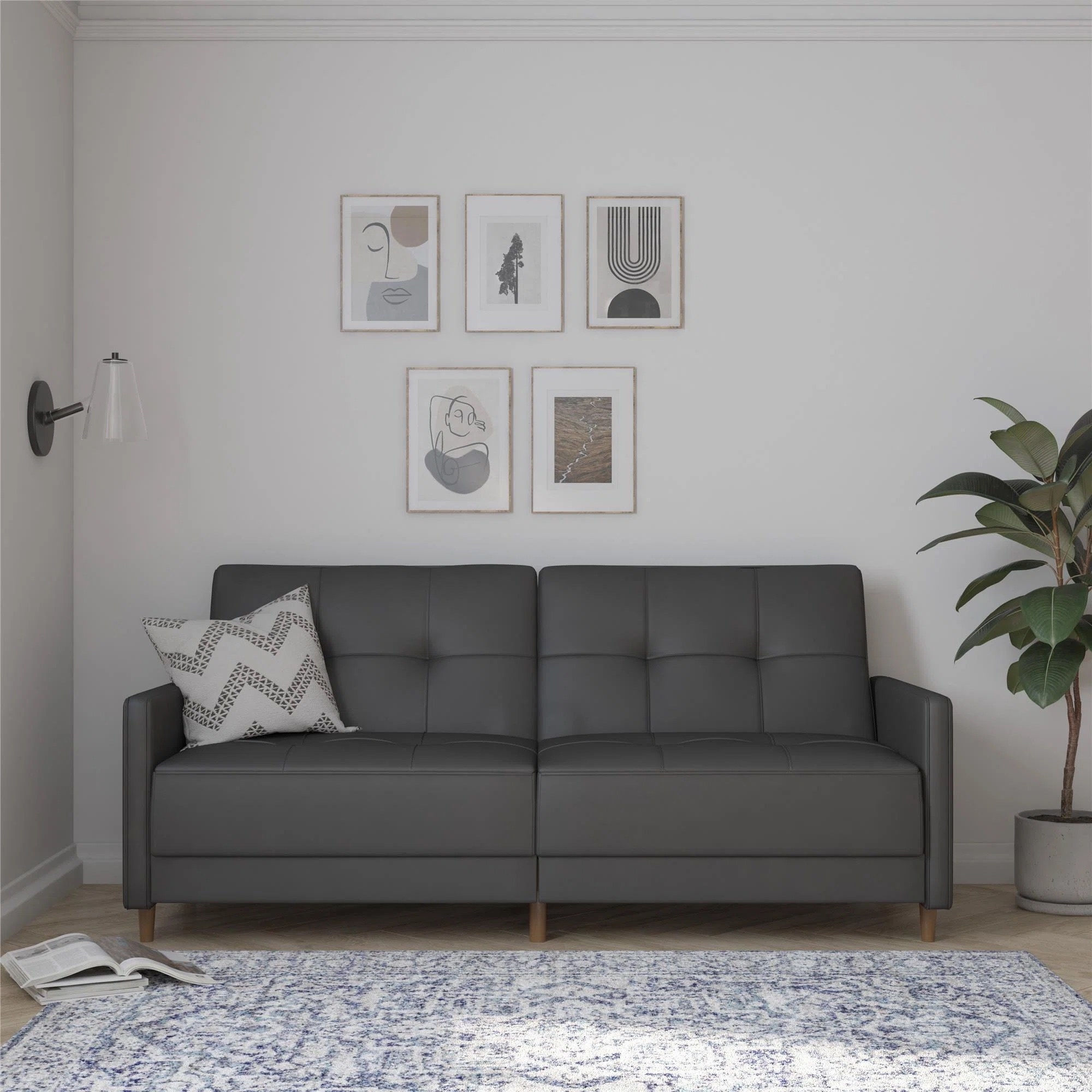 a dark gray faux leather tufted convertible sofa in a living room