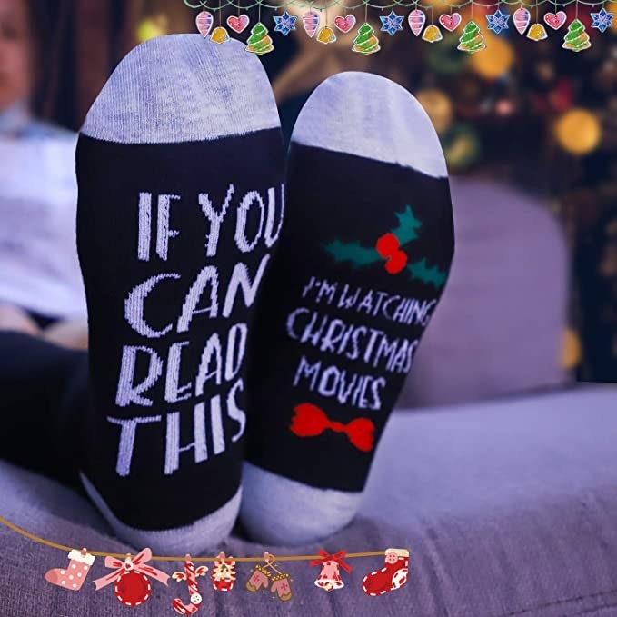 The black and grey socks that say &quot;if you can read this I&#x27;m watching christmas movies&quot;