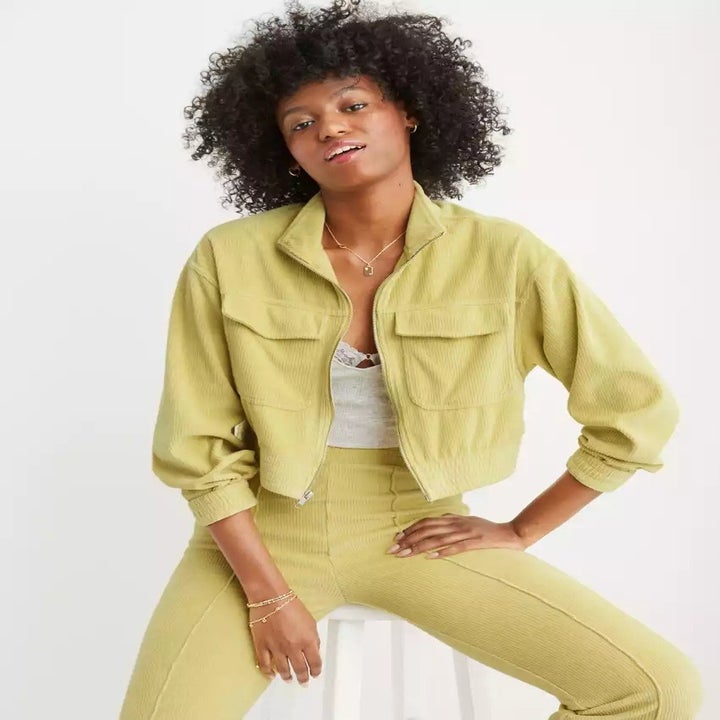 model wearing a chartreuse velour sweatshirt