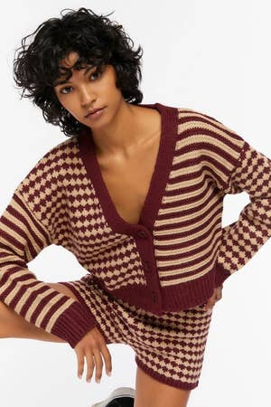 model wearing a maroon and tan cardigan with matching knit shorts