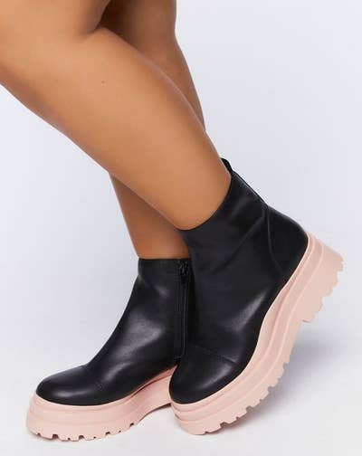 model wearing black and pink faux leather lug boots
