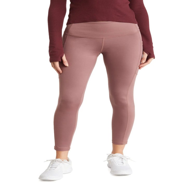 model wearing taupe leggings with white sneakers