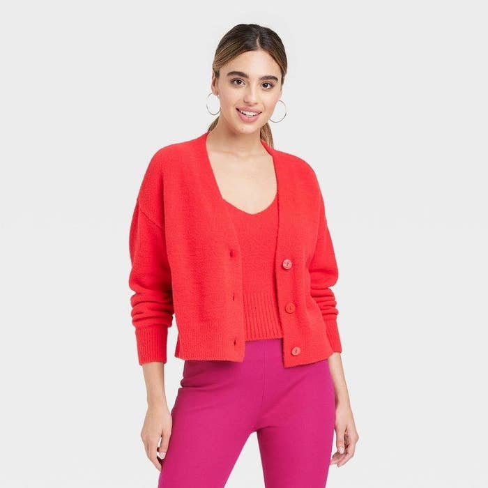 Model wearing red cardigan and matching shirt with pink pants