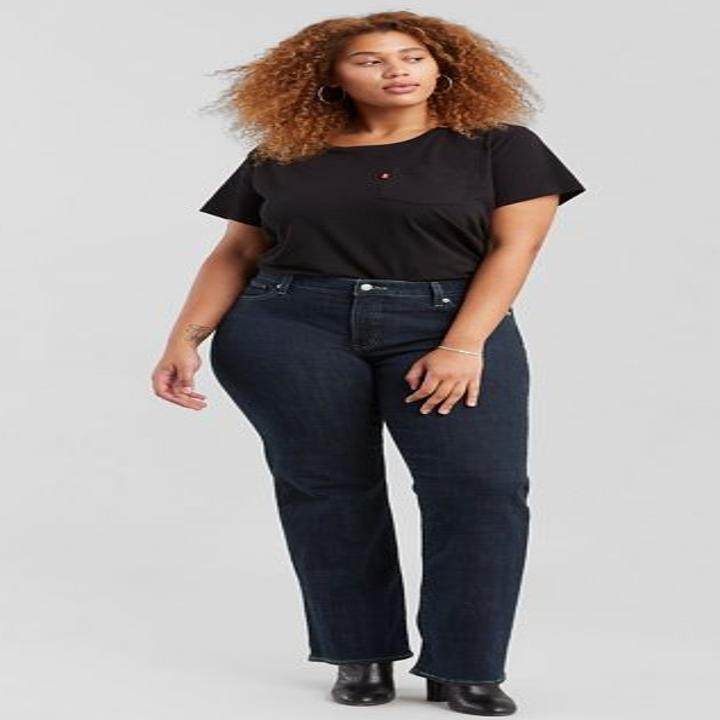 model wearing bootcut jeans in a dark wash with a black top and boots