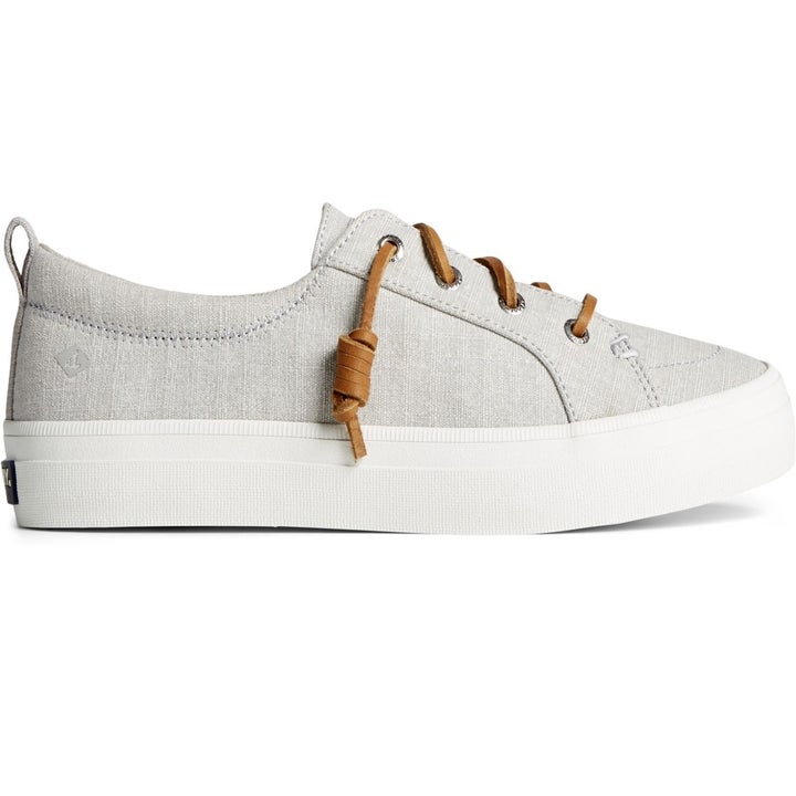 a light gray sneaker with rawhide laces