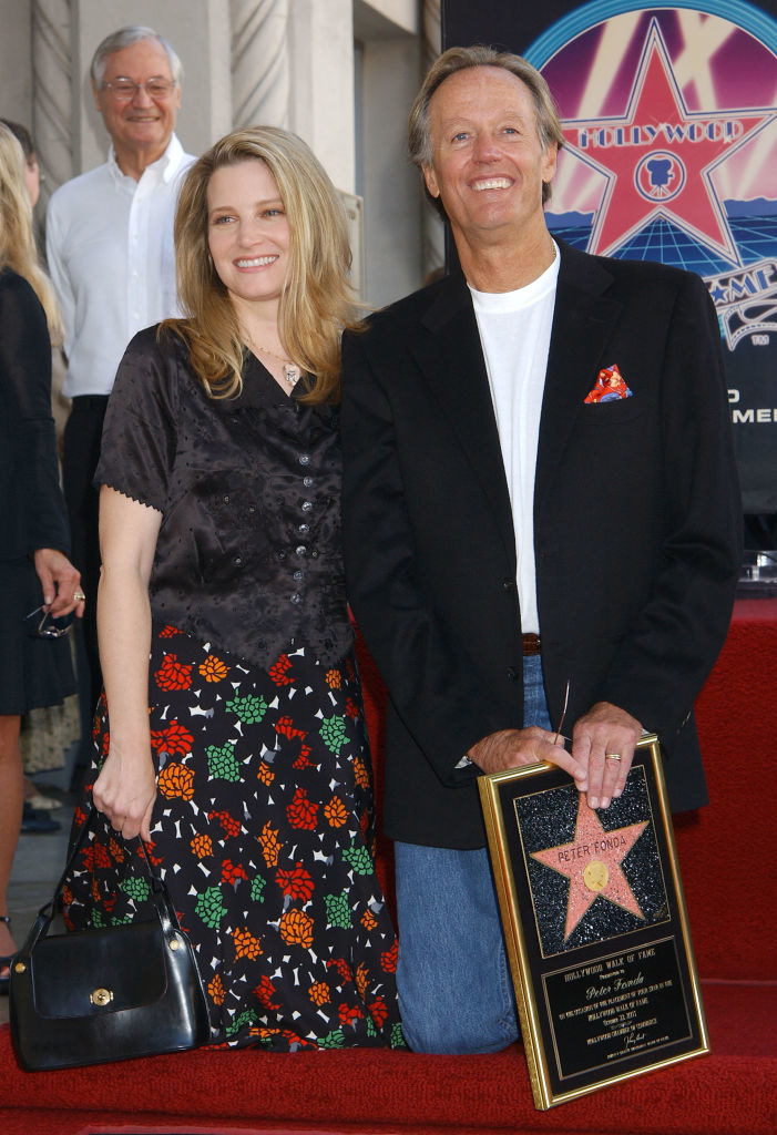 Bridget and Peter smiling as Peter holds his Hollywood Walk of Fame plaque