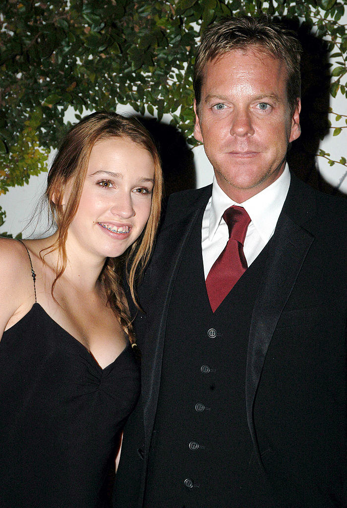 Sarah in a spaghetti-strap outfit and Kiefer in a three-piece suit and tie