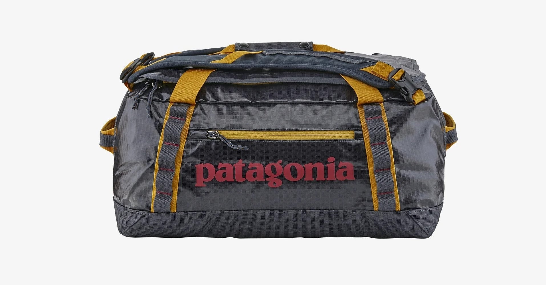 a black duffle bag with yellow accents and the name &quot;patagonia&quot; in red.