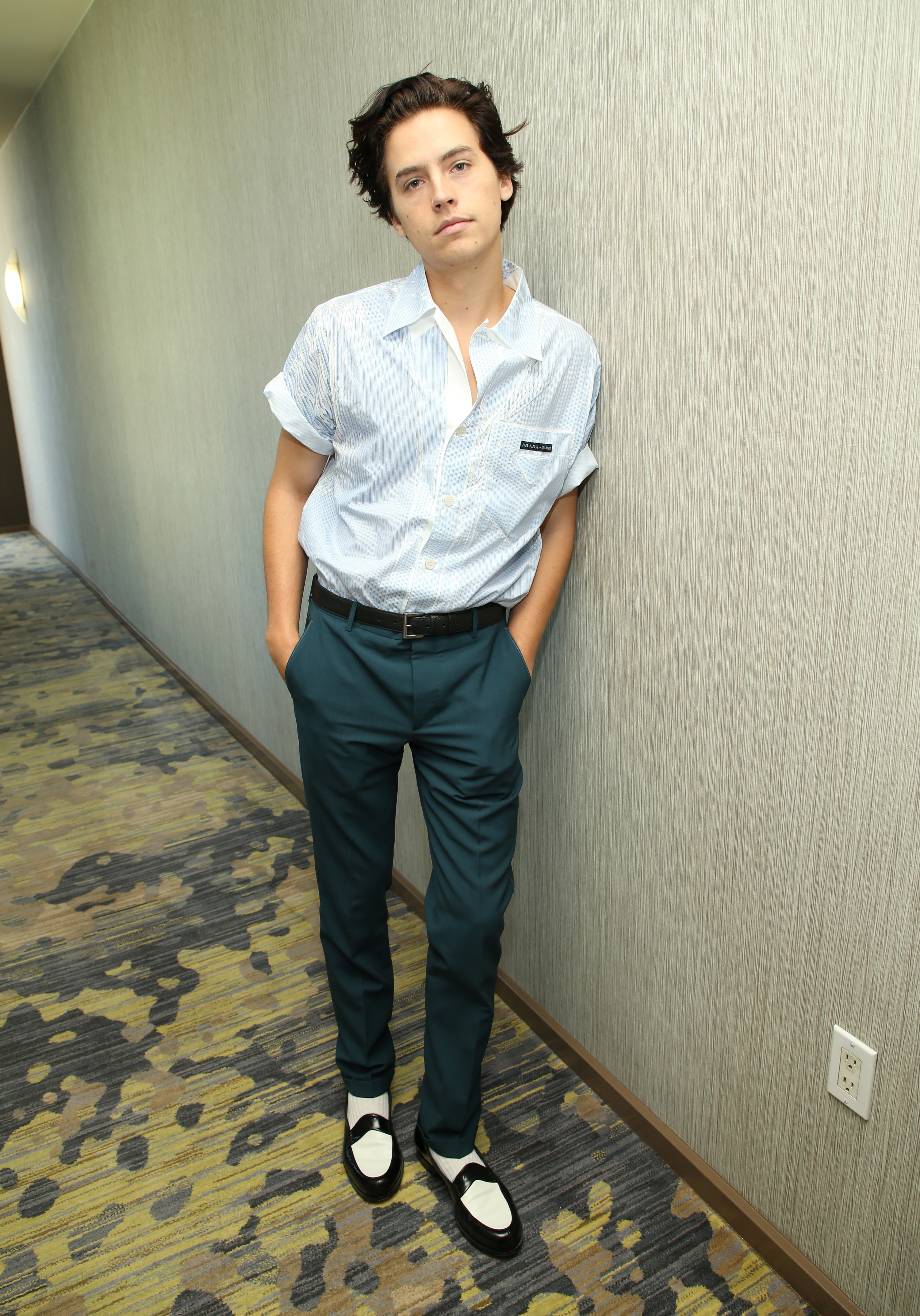 Cole Sprouse in a hallway