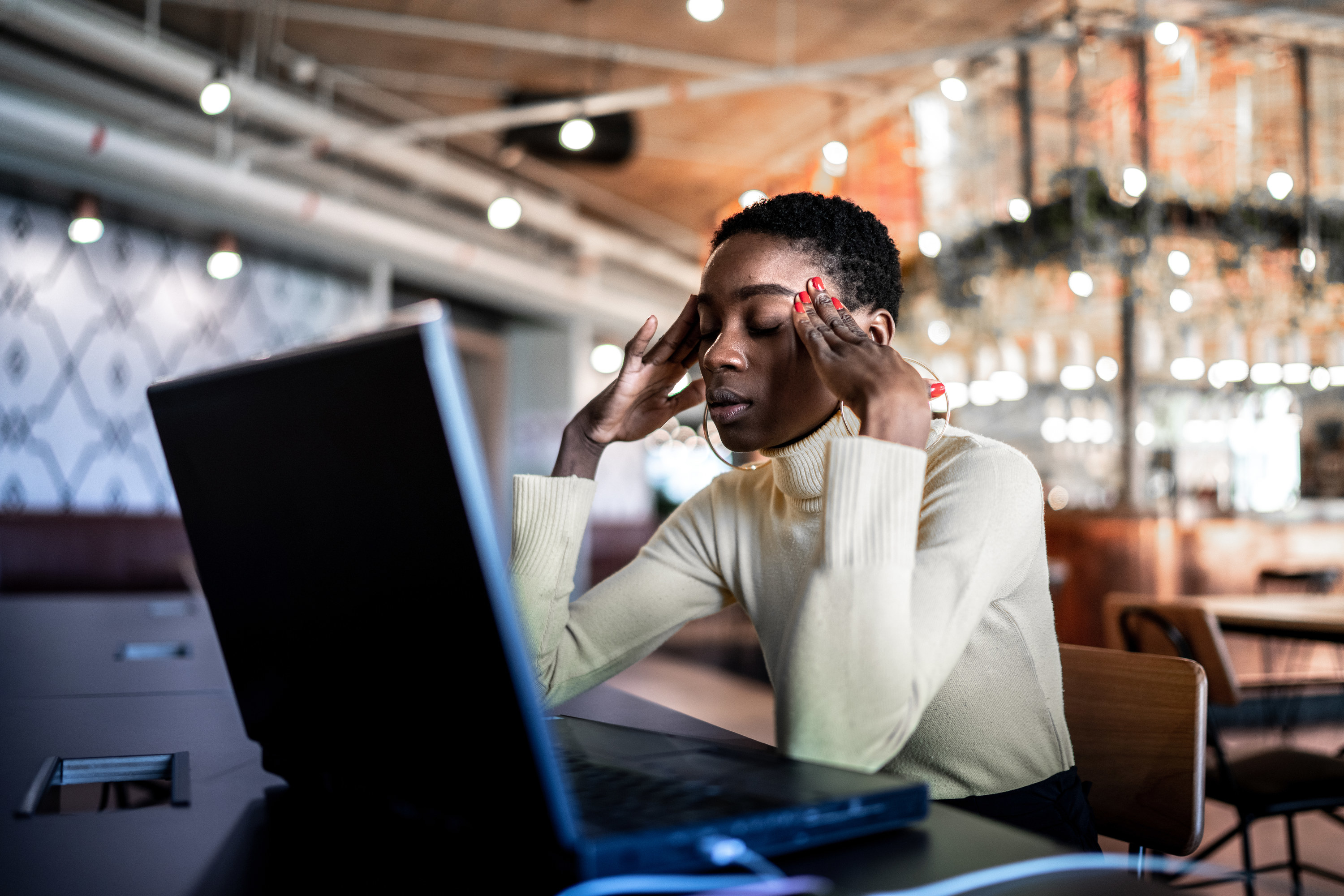 a woman burnt out in front of her computer