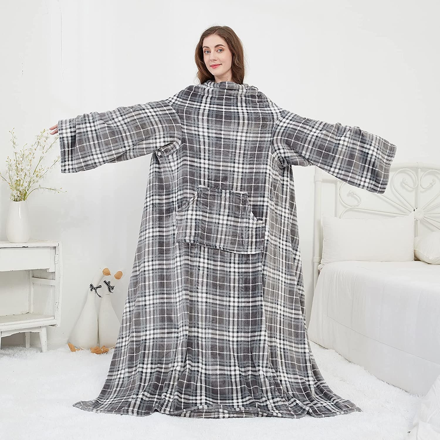 a person standing while wearing the enormous blanket with sleeves