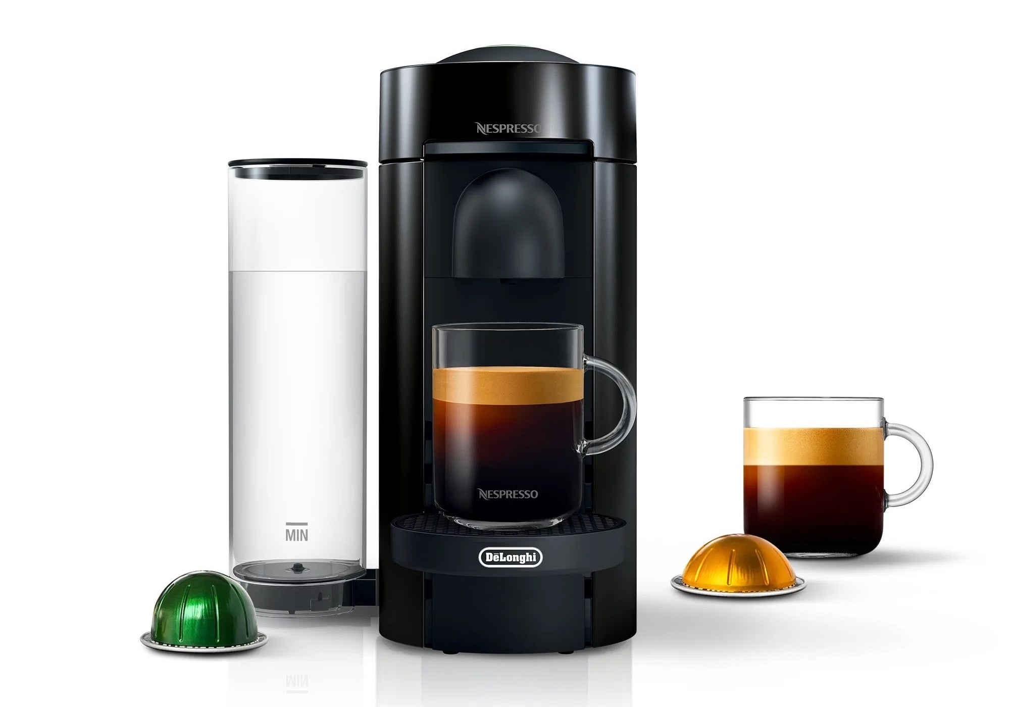 A black coffee maker with a clear water canister, green pod and two mugs of coffee