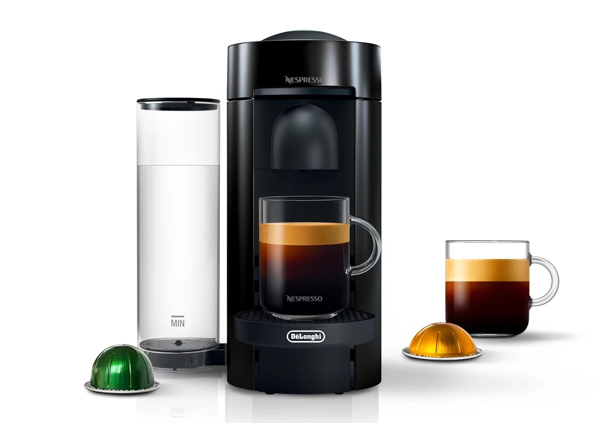 A black coffee maker with a clear water canister, green pod and two mugs of coffee
