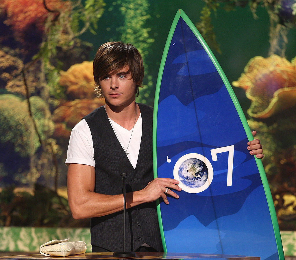 Zac Efron holding a surfbaord