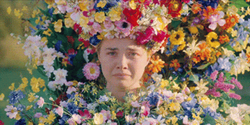 A woman in a flower crown sobbing