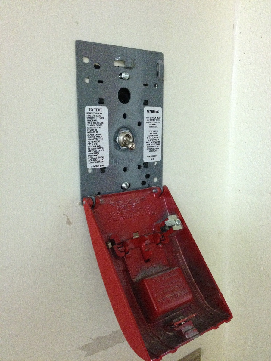The inside of a fire alarm shows a switch