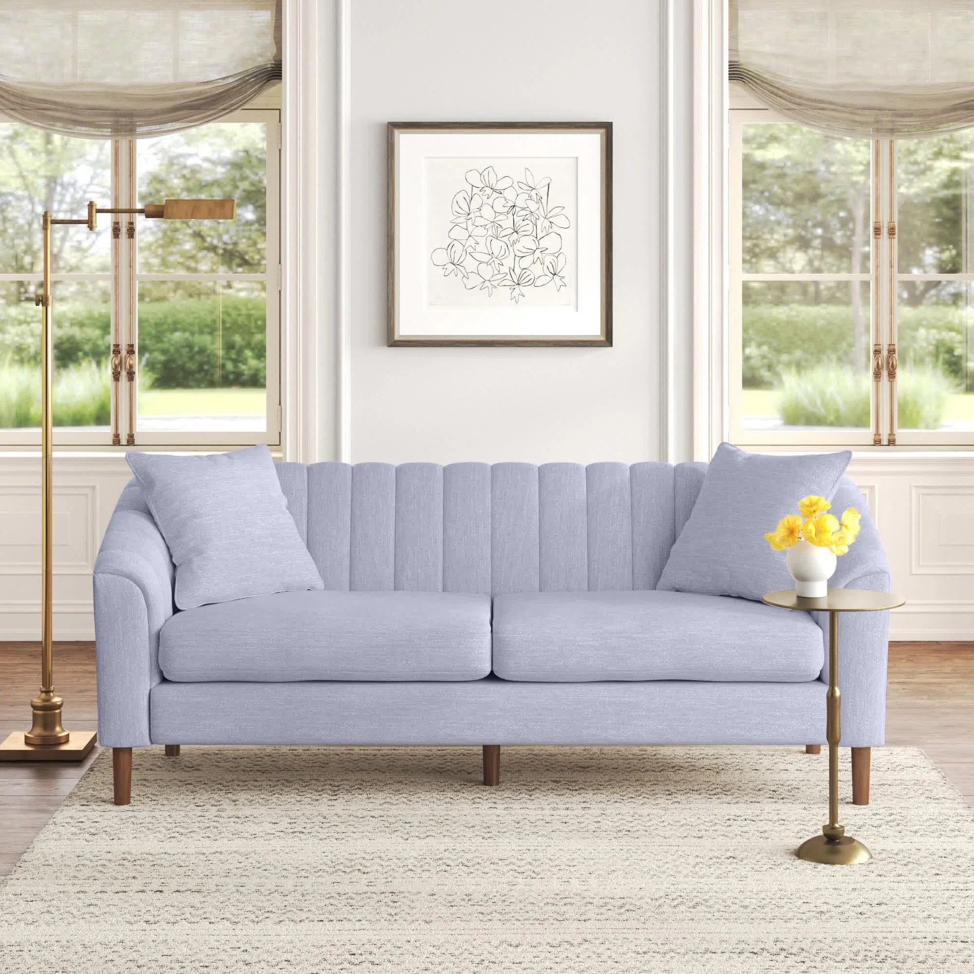 a cloud gray sofa in a living room with wide windows