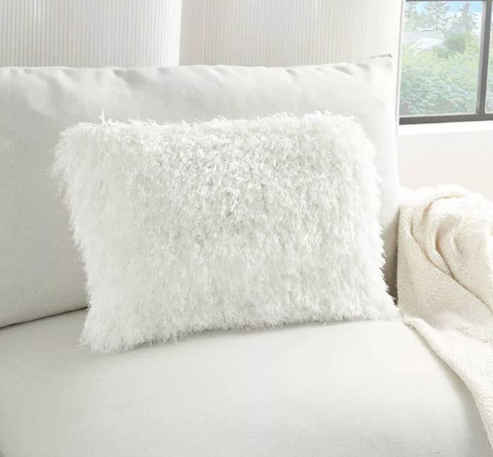 the white fluffy pillow on a couch