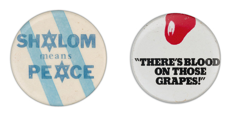 A button on the left reads &quot;shalom means peace&quot; with the A&#x27;s swapped to be stars of David; the button on the right says &quot;there&#x27;s blood on those grapes!&quot; between quote marks, under a small illustrated splotch of blood