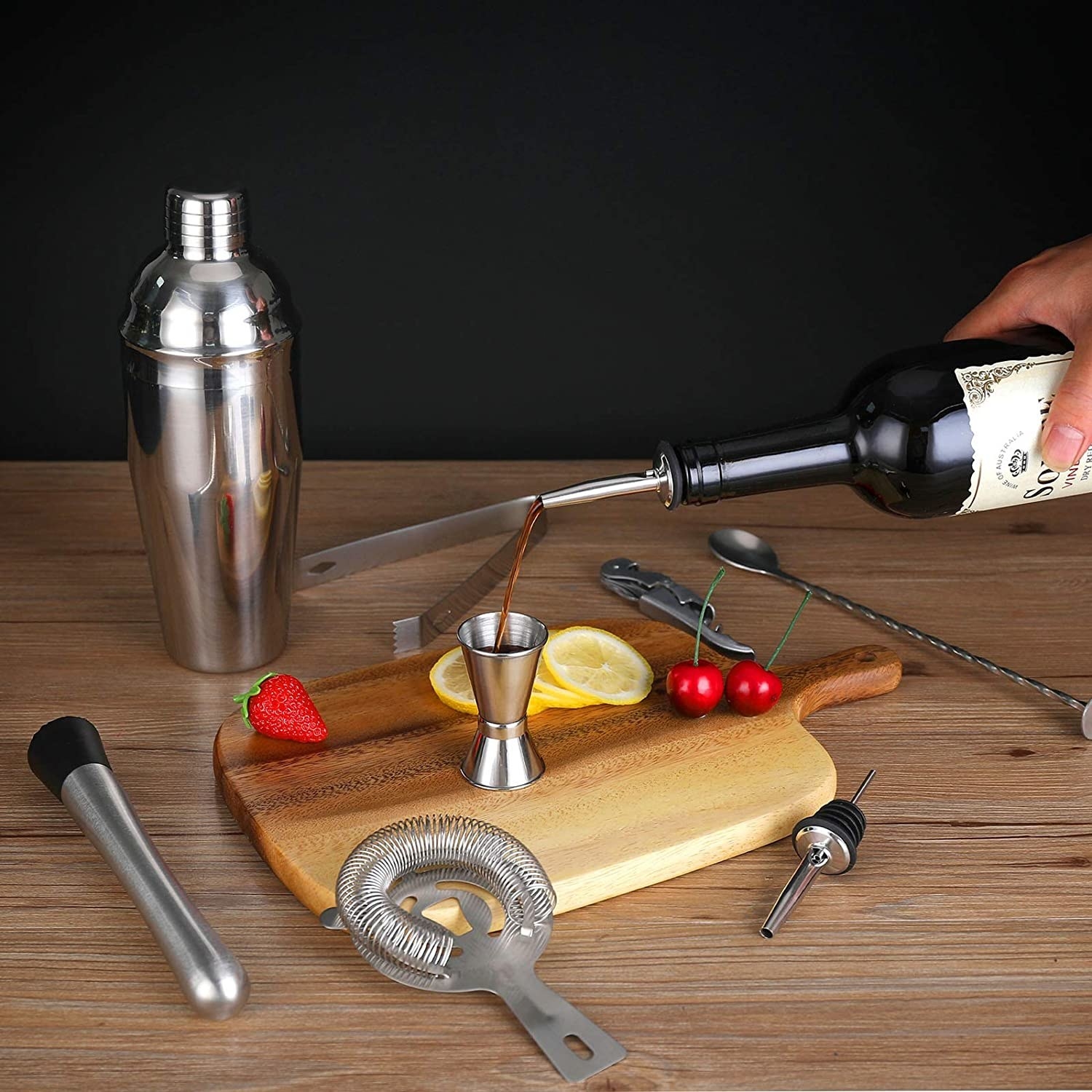 a person using a measuring cup to make a cocktail