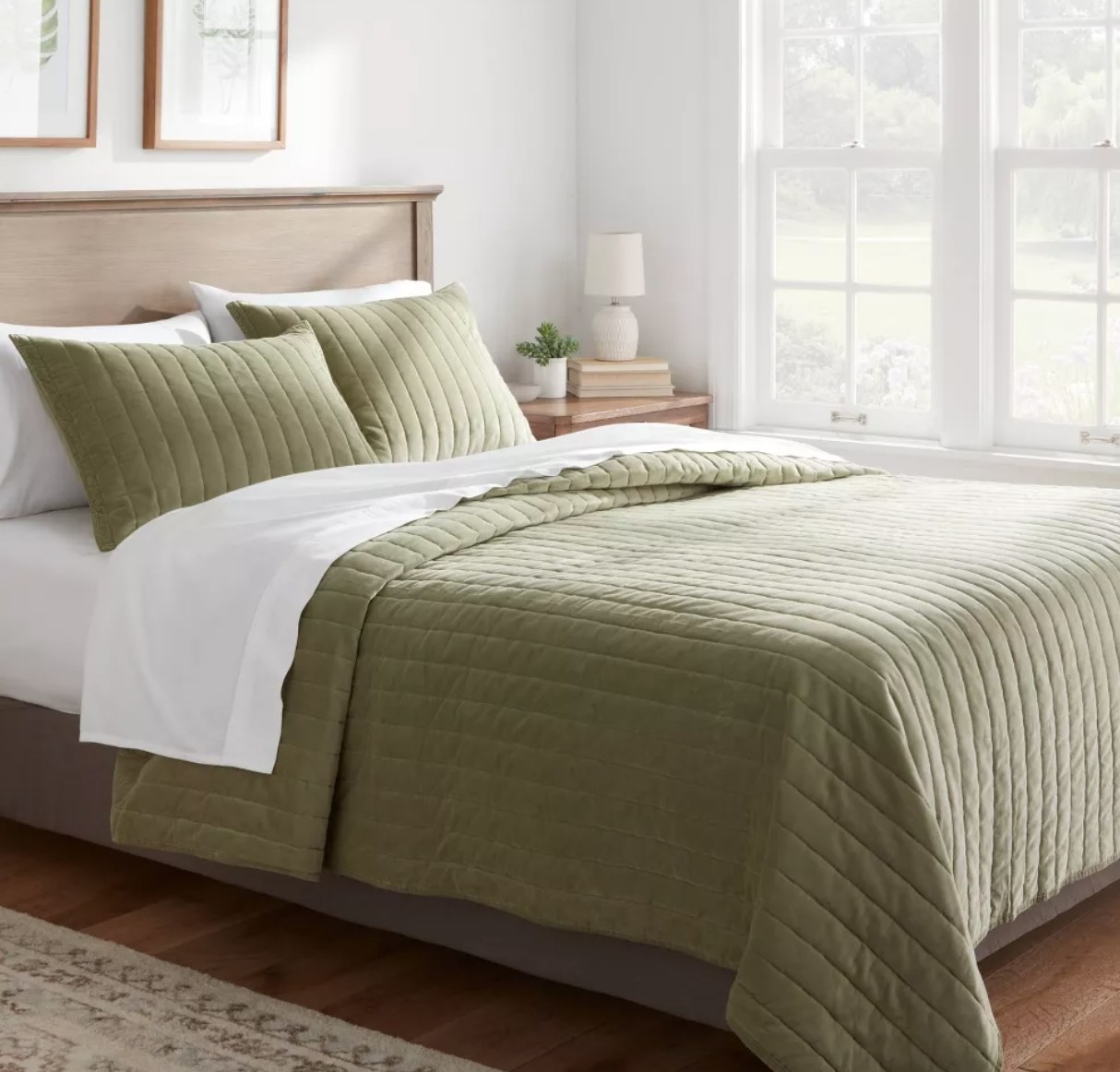 the velvet quilt in green on a bed