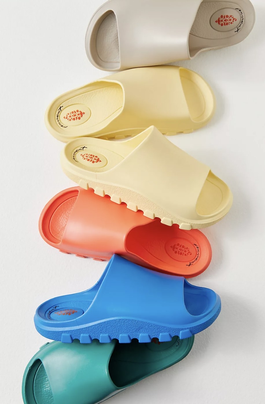 the slippers in green, blue, red, yellow, and beige