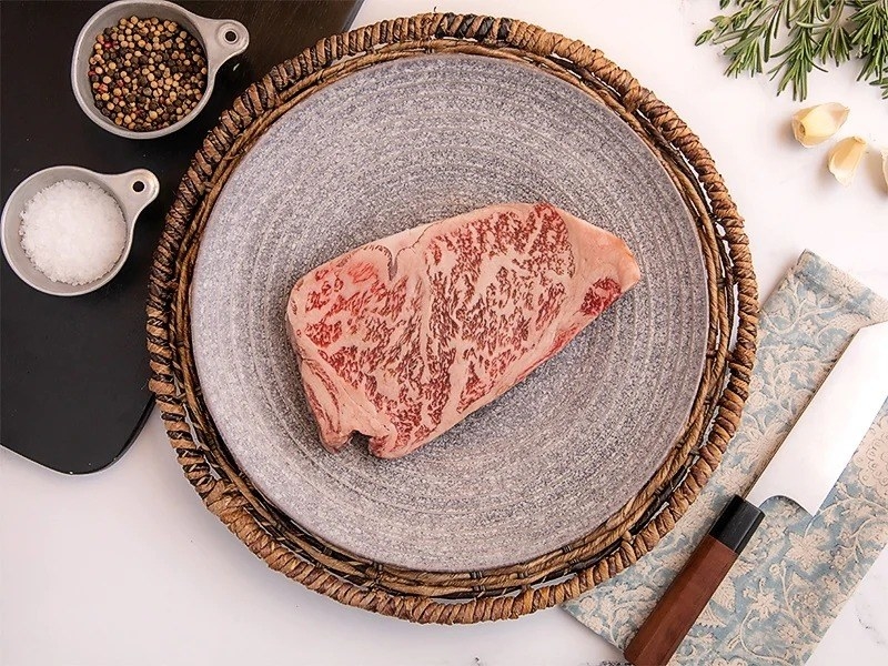 raw Hitachi Gyu A5 Wagyu strip steak on a plate