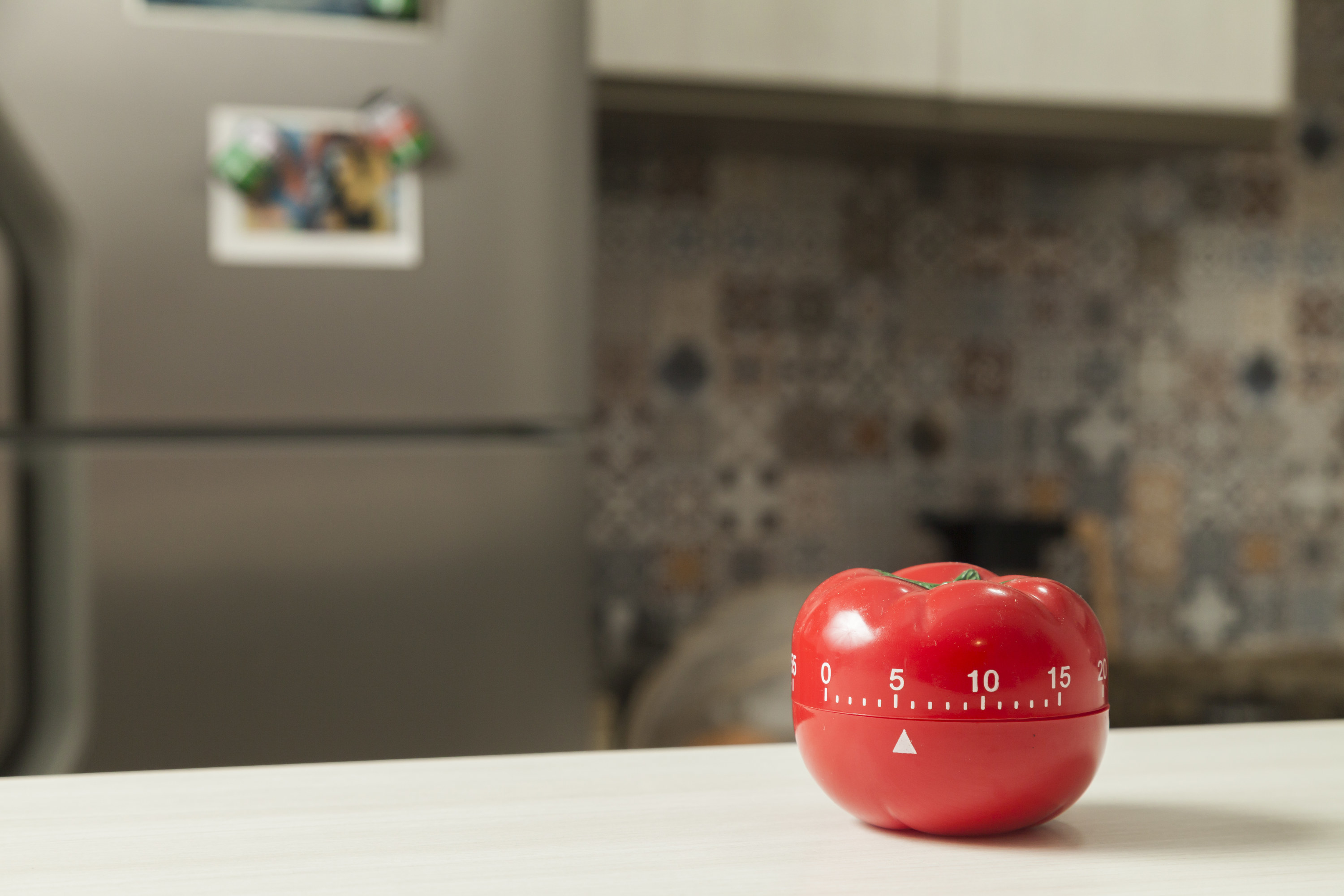 tomato-shaped kitchen timer on a counter