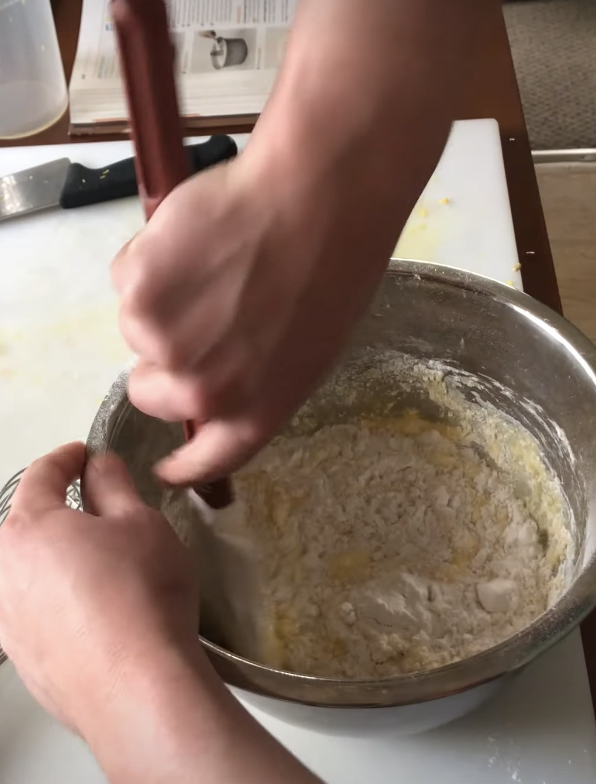 stirring flour and wet ingredients in a large metal bowl
