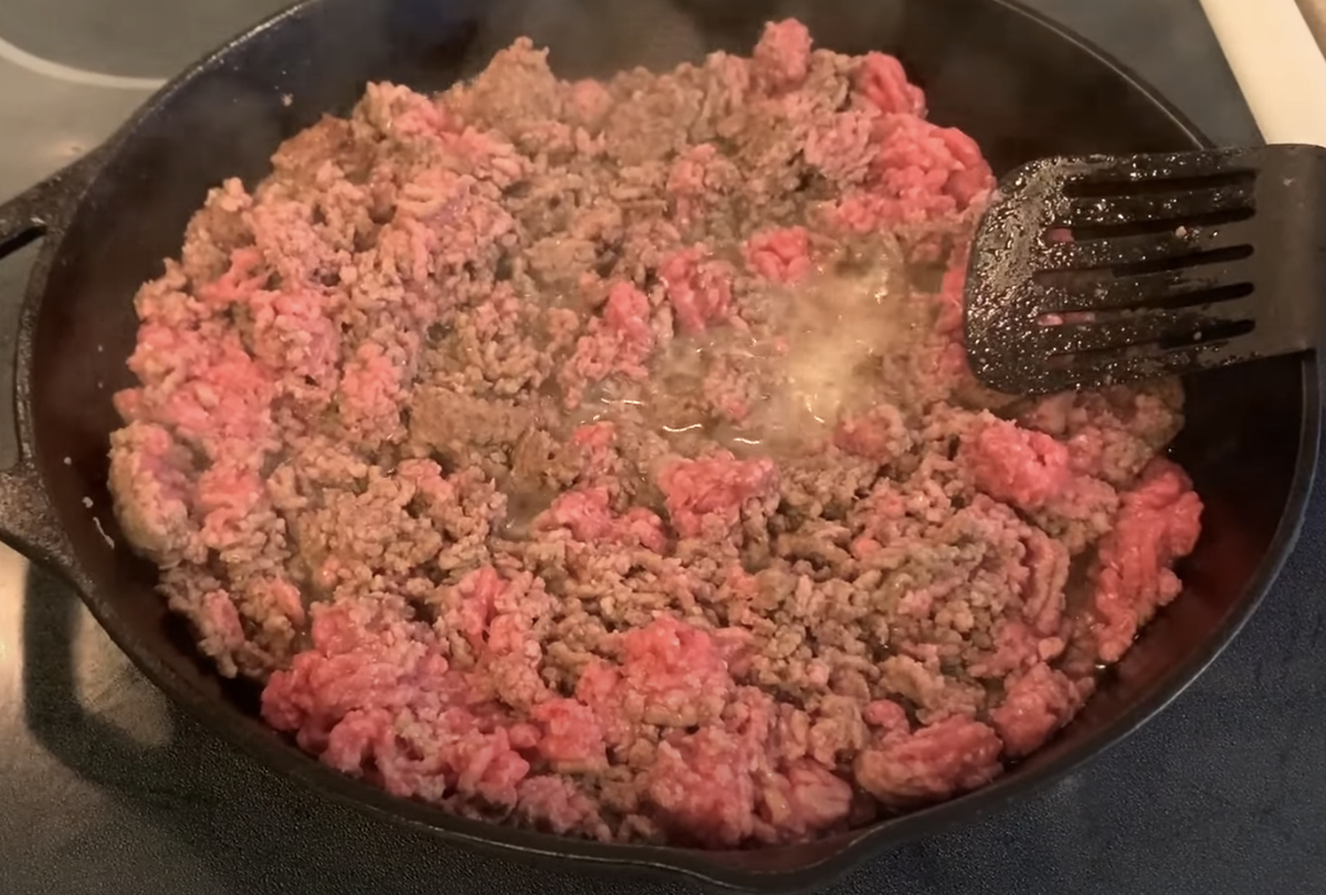 sauteeing ground beef with rendered liquid and fat in the skillet