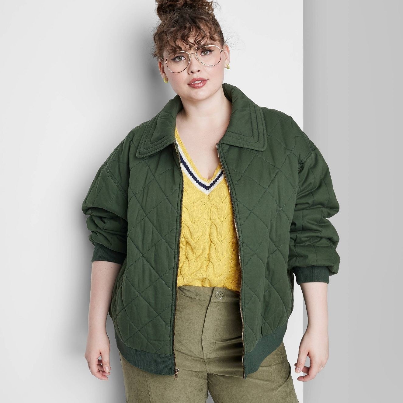 model wearing the green quilted bomber jacket