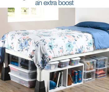 A bed with the bed risers attached to the legs, giving it room to fit a lot of storage underneath