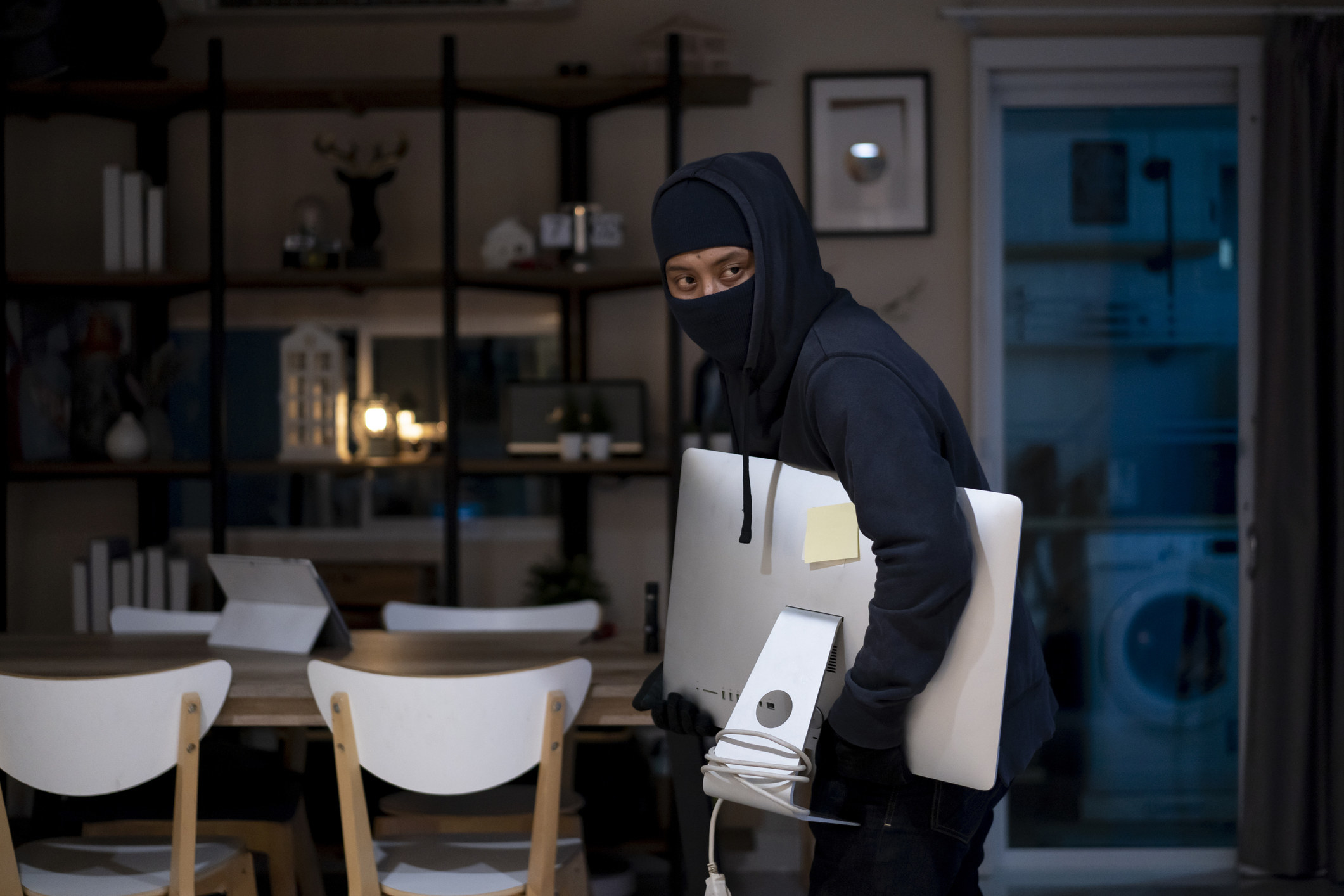 A robber stealing a computer