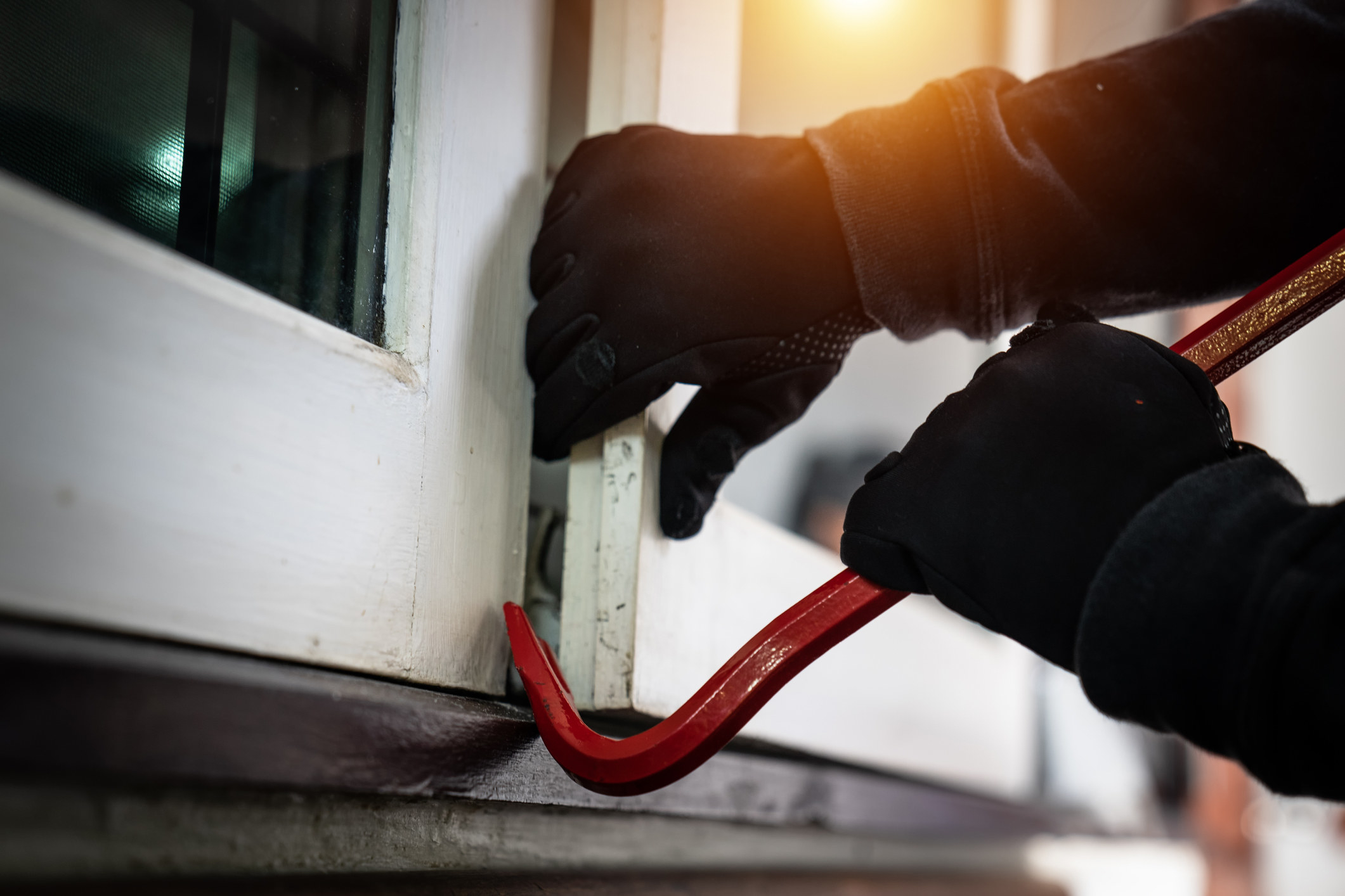 A robber breaking into a house