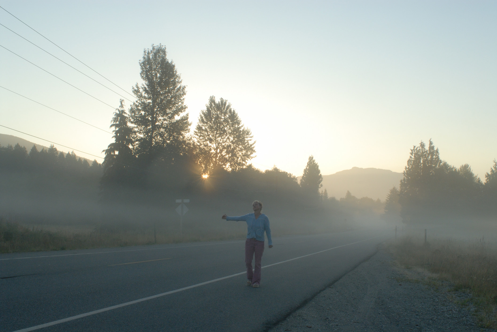 A person hitchhiking