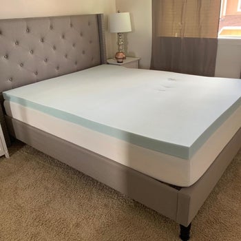 The mattress topper on a reviewer's bed