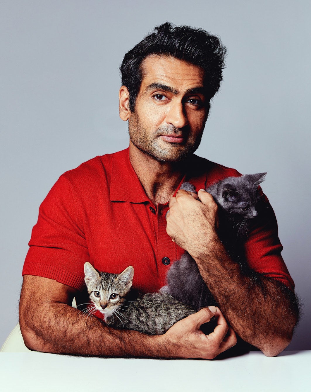 Kumail holding two kittens
