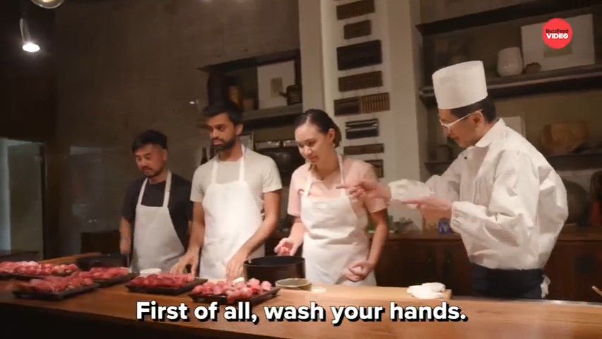 chef telling people to wash their hands first before they touch meat