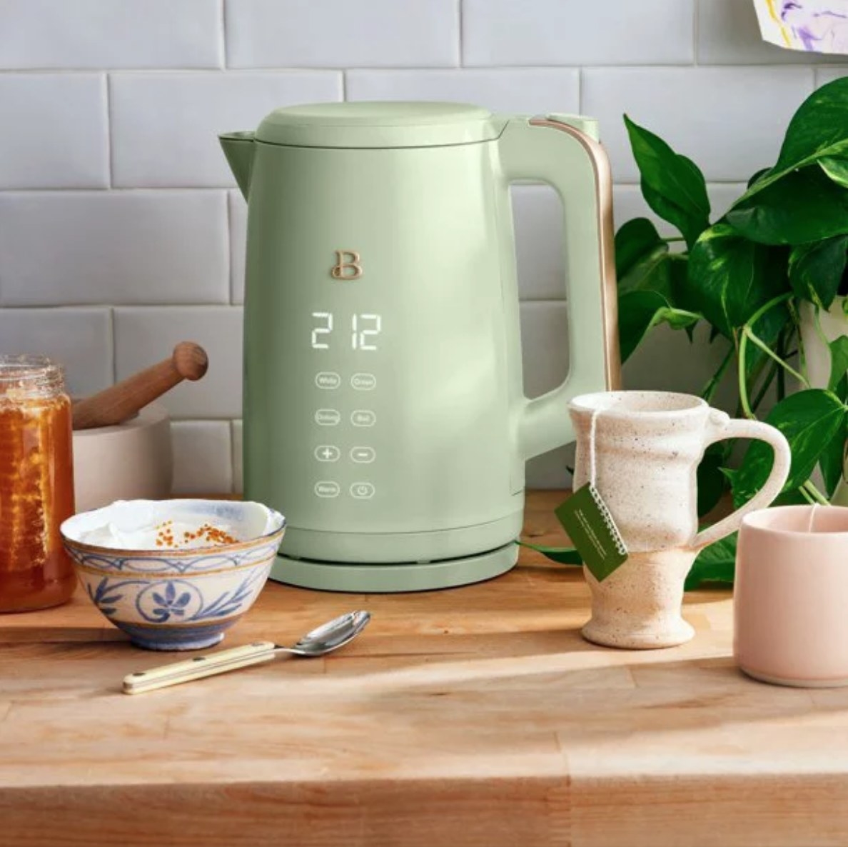 Sage green electric tea kettle on countertop