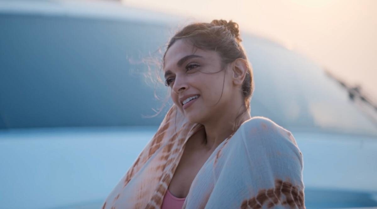 Deepika Padukone smiling while sitting on a yacht