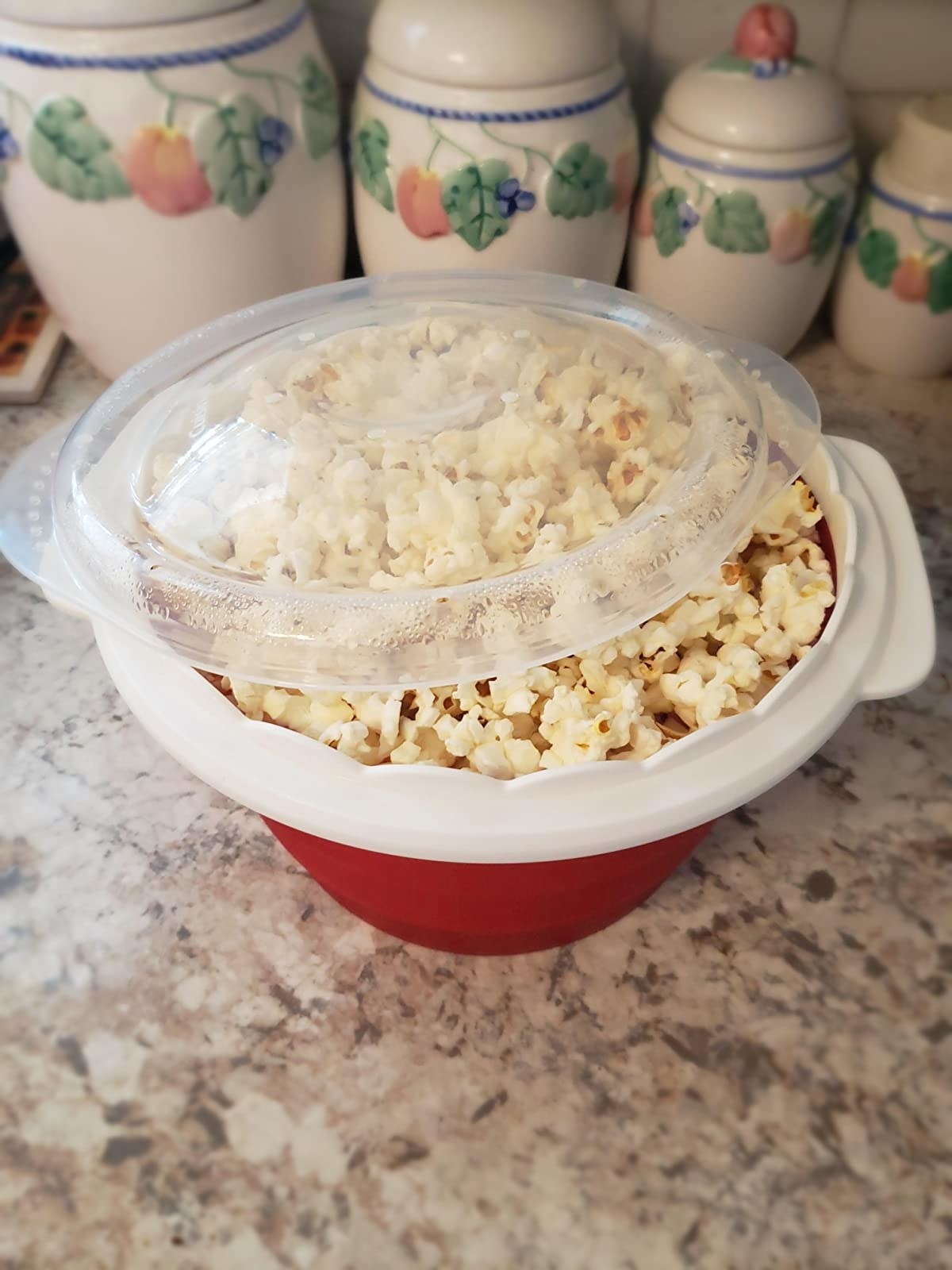 the red bowl with popcorn inside it