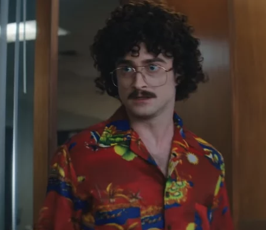 closeup of Daniel in character with a mustache and wired glasses