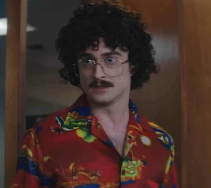 closeup of Daniel in character with a mustache and wired glasses