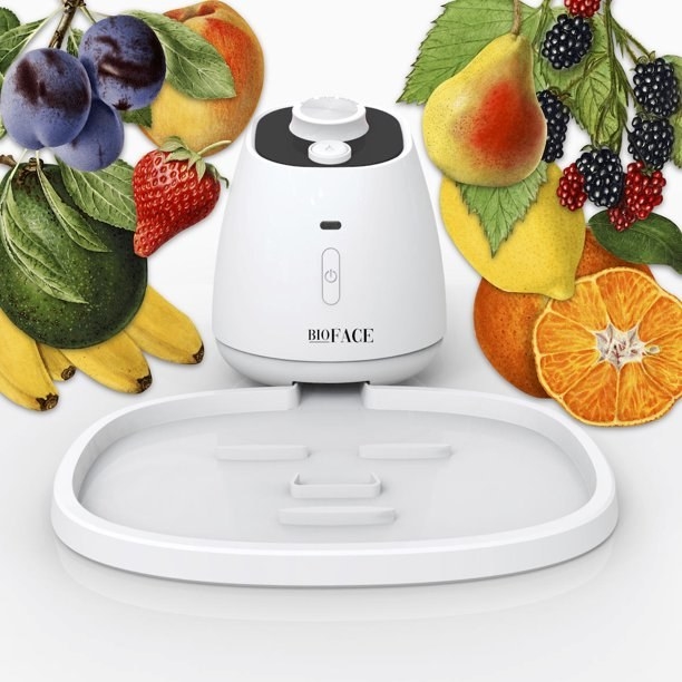 Bioface face mask machine and mask tray surrounding by images of fruits and vegetables