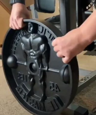 a person holding a dumbbell right where their crotch is