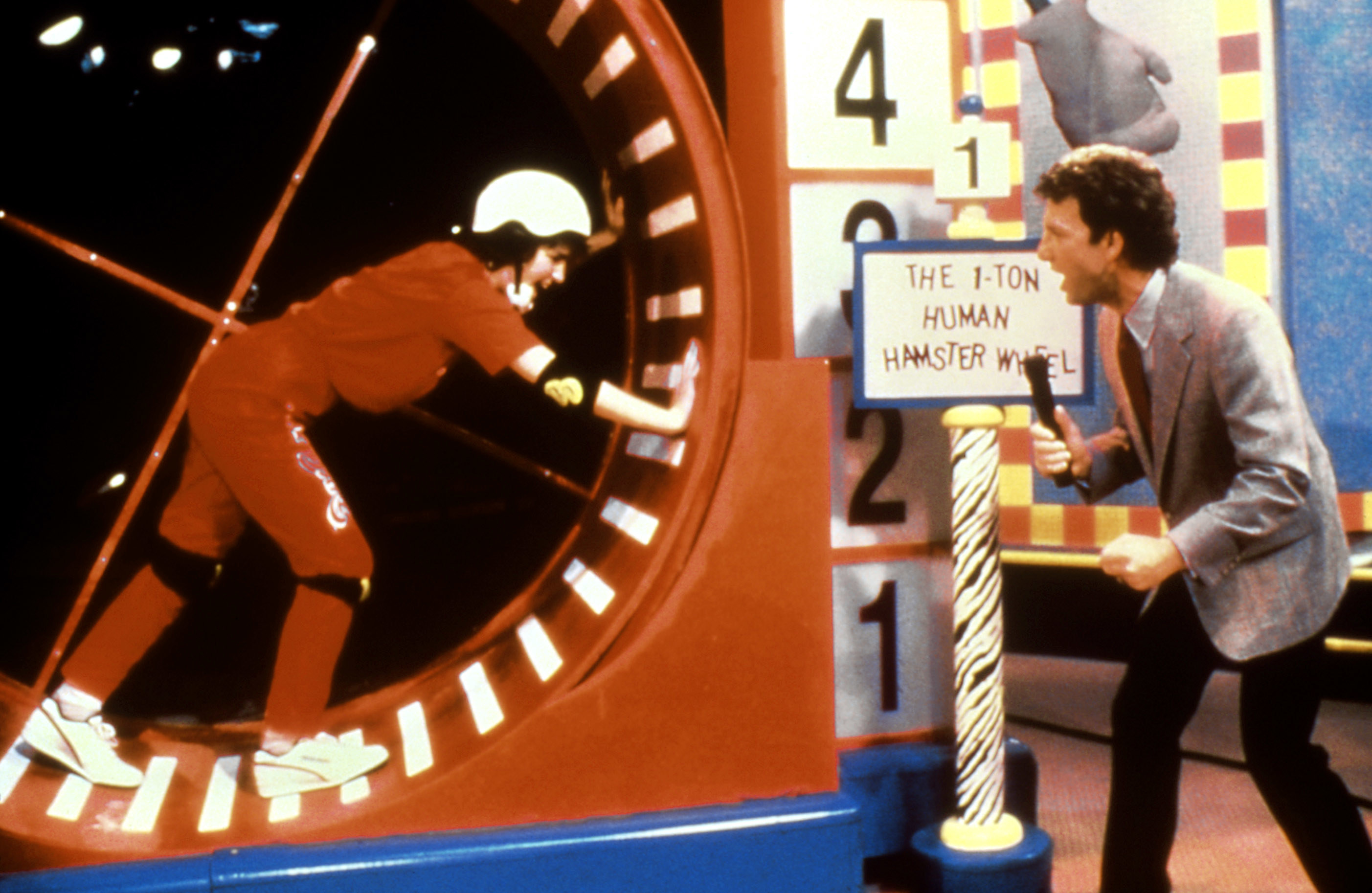 teen running inside a large hamster wheel